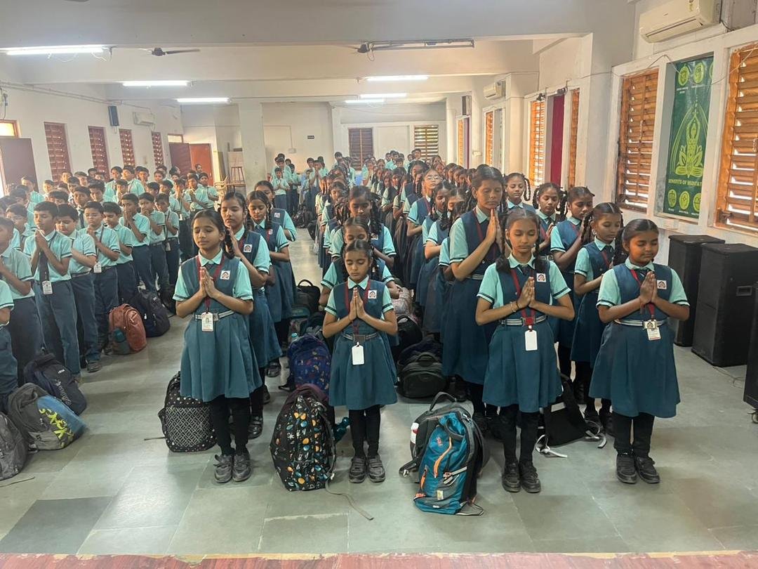Students praying during assembly